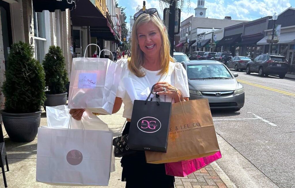 a woman with shopping bags in downtown apex