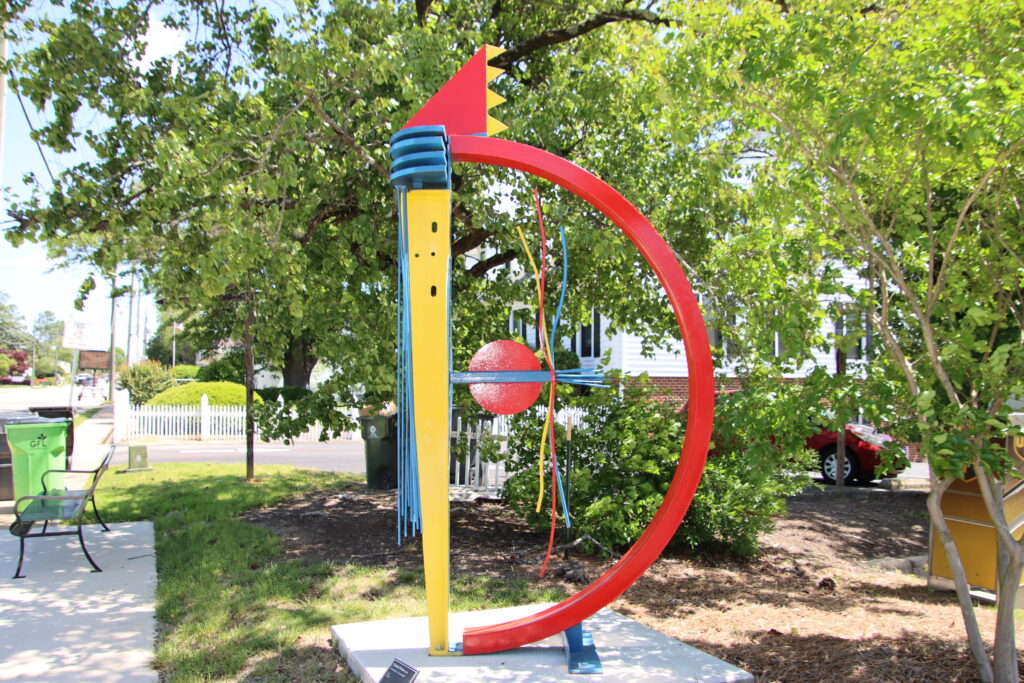 yellow and red art sculpture in downtown apex