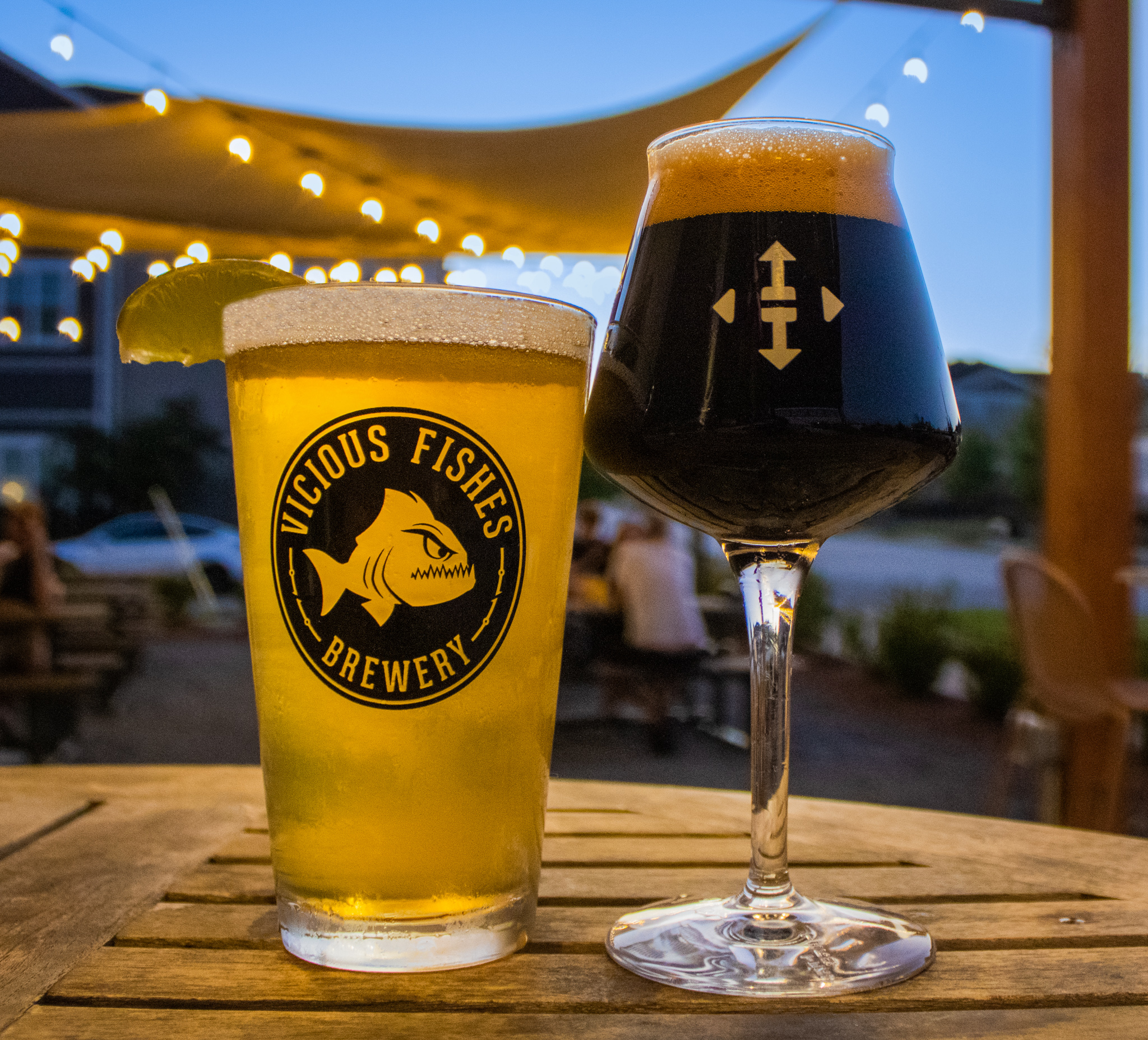 two glasses of beers on a table