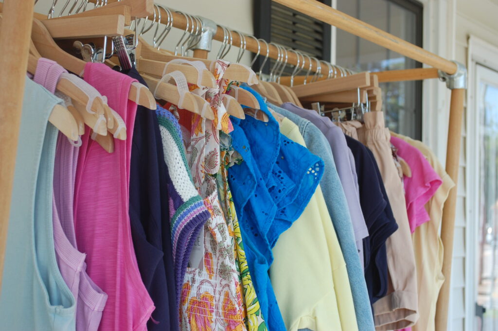 photos of clothes on a rack at a boutique