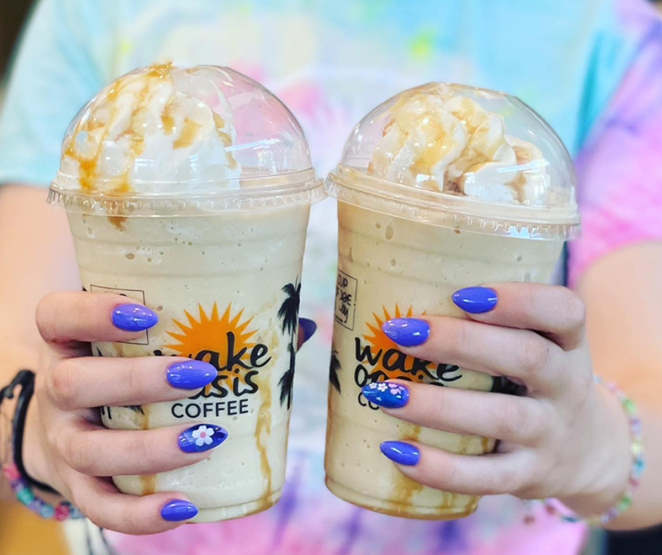 a girl holding two Frappuccinos