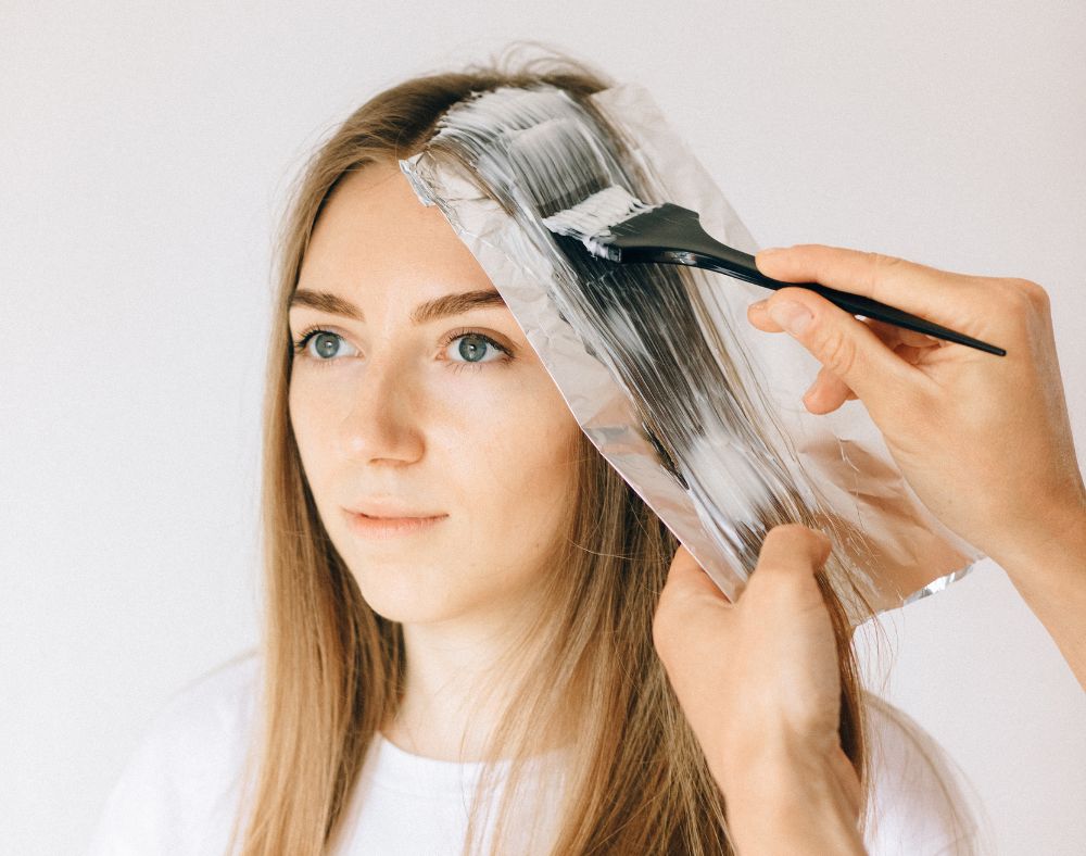 a woman getting her hair colored