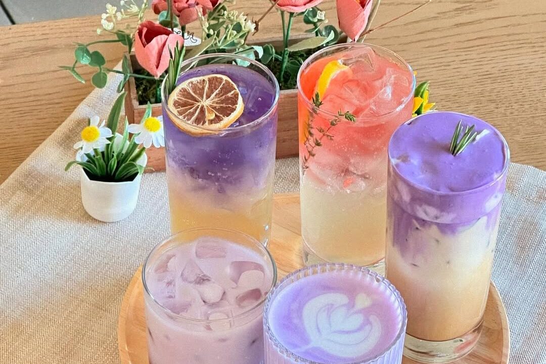 Sweet Talk Cafe - Five colorful drinks with flowers in back