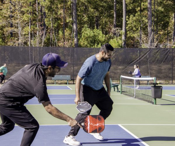 two men playing pickleball