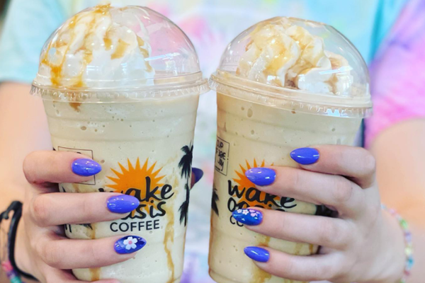 a girl holding two Frappuccinos