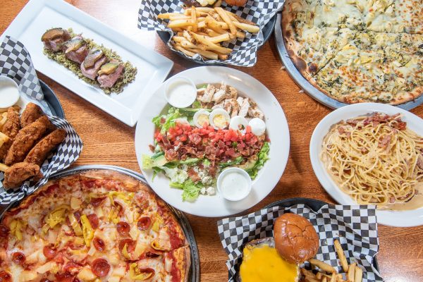 platter of foods such as salad, pizza, and wings